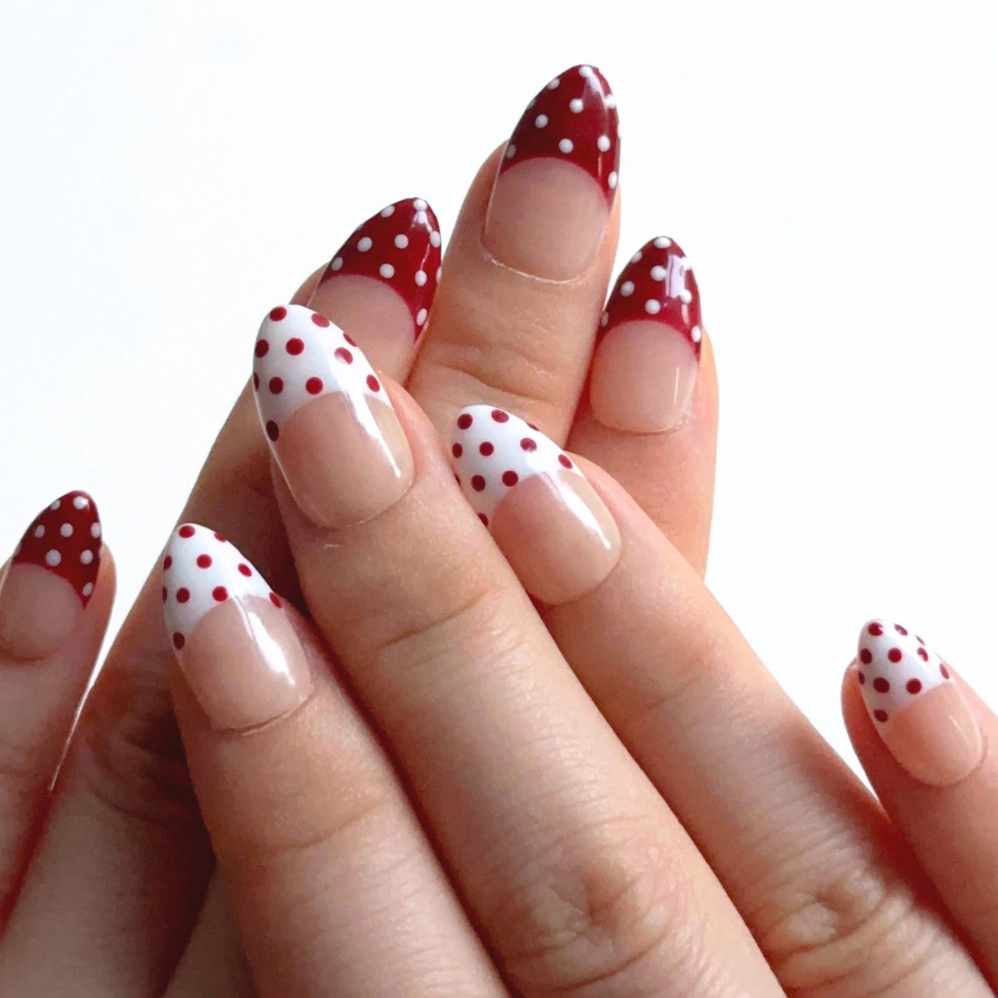 Apple Snow is a reusable handmade press-on nails set by Leme. The design delivers timeless elegance with a nude base and crisp red-and-white French tips adorned with delicate dot detailing. Each set combines precision craftsmanship with versatile styling—choose from multiple shapes and lengths to match your aesthetic and lifestyle. High-quality materials ensure durability and a flawless finish that rivals salon results. Perfect for those seeking a sophisticated, season-spanning manicure that transitions eff