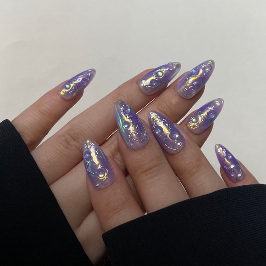 Aurora Tide is a reusable handmade press-on nails set by Leme. The set features a sophisticated chrome finish and a medium almond shape, offering a durable and sleek surface that resists tarnish. Its high-quality 3D design provides depth and texture, enhancing visual appeal while ensuring lasting performance. Ideal for those seeking a refined and modern aesthetic, this piece combines expert craftsmanship with functional elegance.