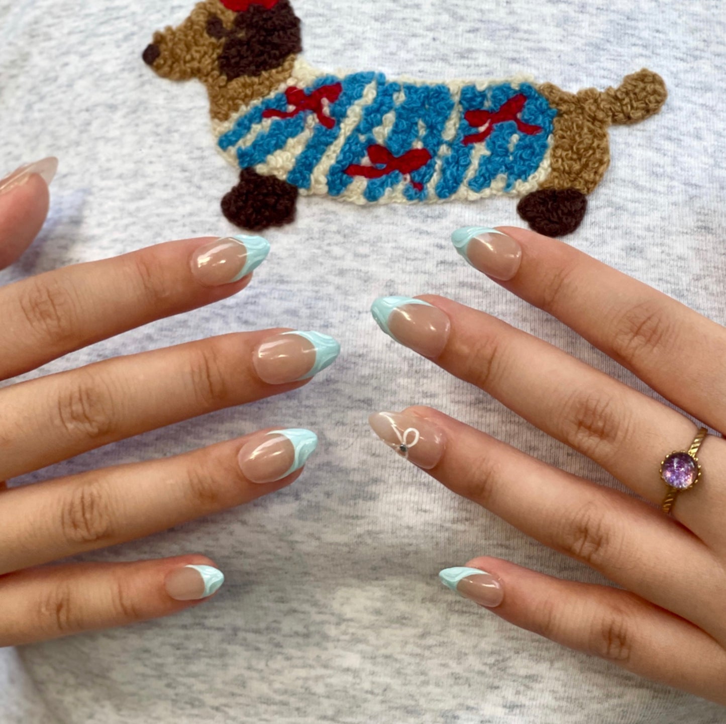 Blue Serenity is a reusable handmade press-on nails set by Leme. These high-quality 3D nails feature a short almond shape with elegant French tips. The delicate baby blue and nude colors create a sophisticated, modern look perfect for any occasion. Designed for durability and style, they offer a flawless finish that enhances your natural nails with expert craftsmanship.