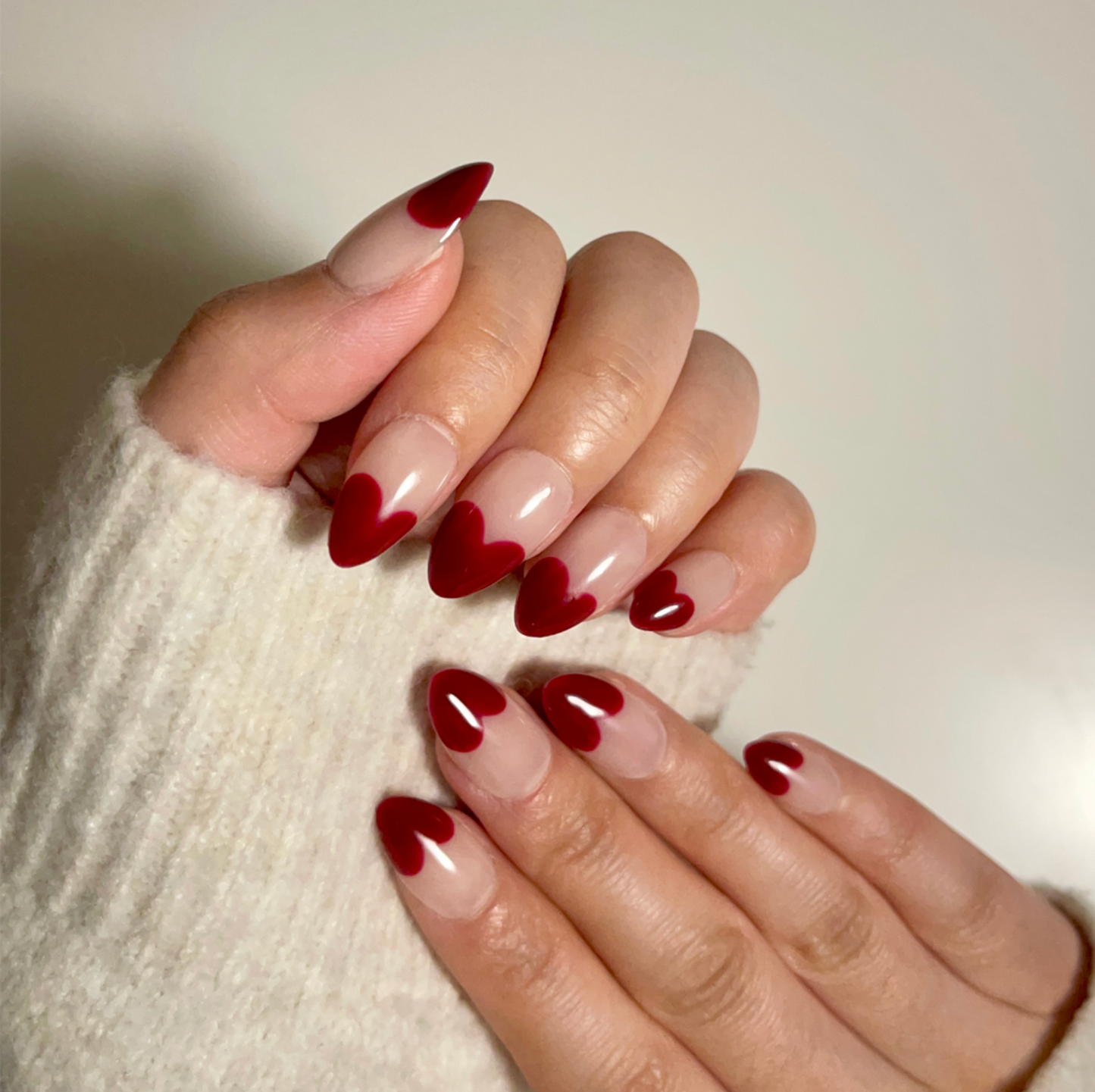 Retro Heart is a reusable handmade press-on nails set by Leme. This collection features short almond-shaped nails in classic red and nude tones. Handmade with high-quality materials, these reusable nails offer a sophisticated French-inspired look that combines timeless style with durability. Perfect for those seeking a refined, expert touch to their manicure routine.