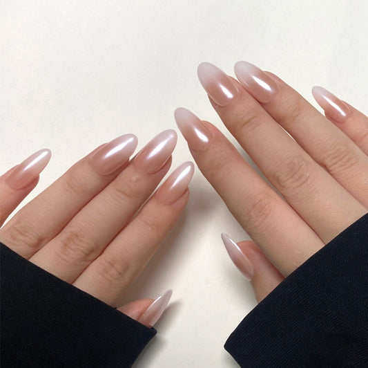 Tipsy is a reusable handmade press-on nails set by Leme. Featuring a medium-length oval shape, each nail showcases a high-quality chrome finish with a seamless gradient from nude to pristine white. This sophisticated design delivers a subtle yet striking appearance, ideal for those who appreciate refined, modern style with lasting wear.