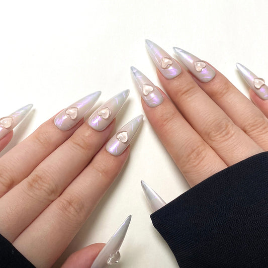 Time Machine is a reusable handmade press-on nails set by Leme. Elevate your nail art with the "Time Machine" set, featuring high-quality, long stiletto-shaped nails. Each piece showcases a sophisticated nude and silver base, enhanced by a striking purple-pink chrome finish. The standout 3D heart decoration adds a unique, expert touch, perfect for those seeking a blend of elegance and bold style. Ideal for making a lasting impression with refined craftsmanship and contemporary design.