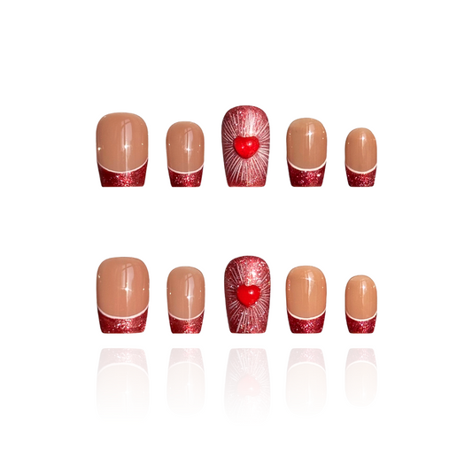 Amour is a reusable handmade press-on nails set by Leme. Elevate your manicure with Amour, our Valentines' special coffin-shaped nails featuring a sophisticated nude base and striking red glitter French tips. Delicate 3D hearts adorned on the middle fingers add a romantic, dimensional touch that catches light beautifully. Meticulously crafted for a flawless finish, these high-quality nails deliver salon-worthy elegance with effortless glamour. Perfect for special occasions or everyday luxury.