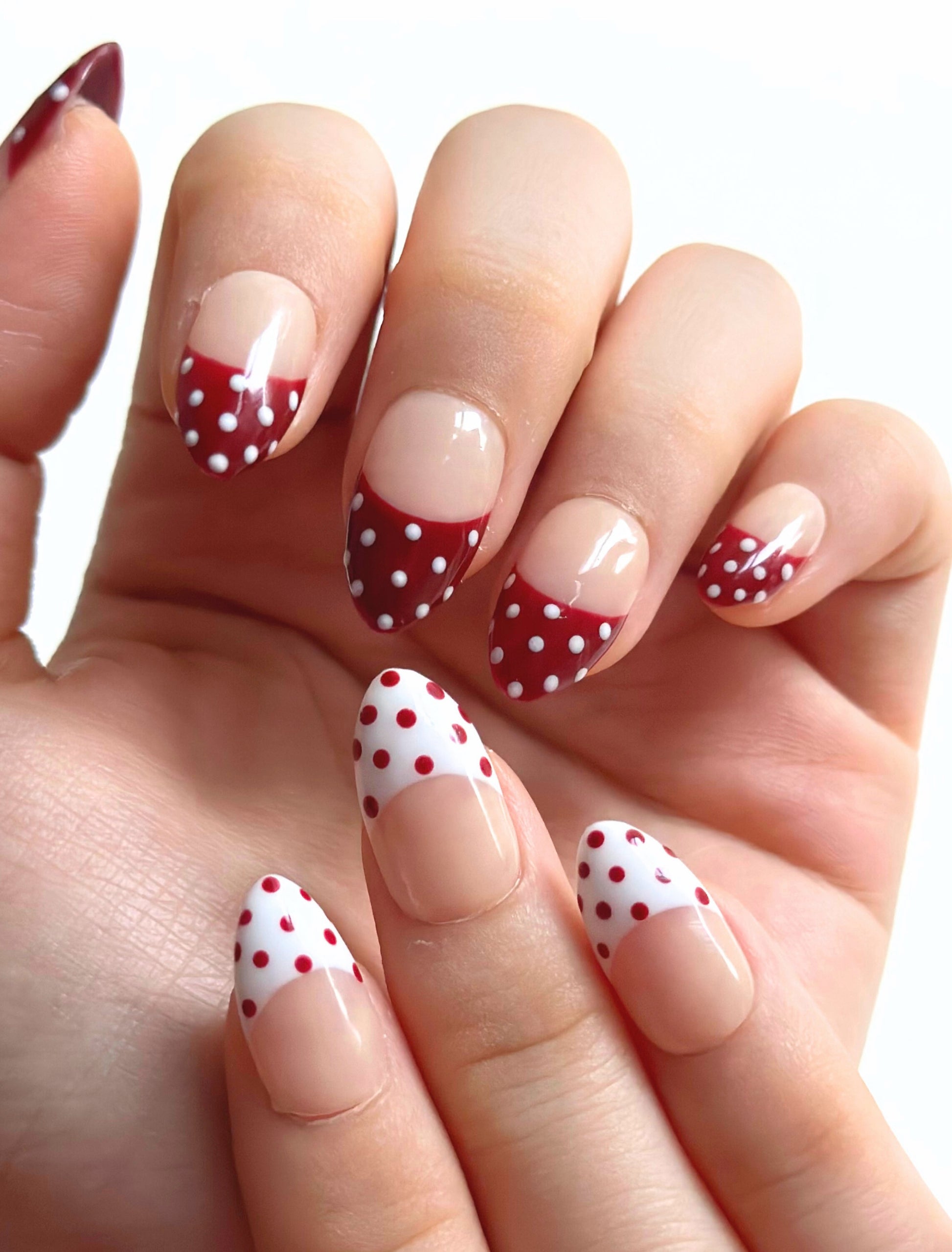 Apple Snow is a reusable handmade press-on nails set by Leme. The design delivers timeless elegance with a nude base and crisp red-and-white French tips adorned with delicate dot detailing. Each set combines precision craftsmanship with versatile styling—choose from multiple shapes and lengths to match your aesthetic and lifestyle. High-quality materials ensure durability and a flawless finish that rivals salon results. Perfect for those seeking a sophisticated, season-spanning manicure that transitions eff