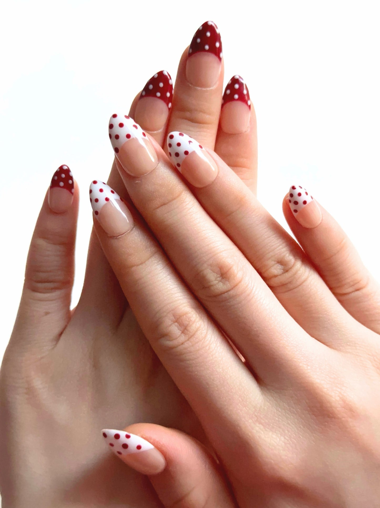 Apple Snow is a reusable handmade press-on nails set by Leme. The design delivers timeless elegance with a nude base and crisp red-and-white French tips adorned with delicate dot detailing. Each set combines precision craftsmanship with versatile styling—choose from multiple shapes and lengths to match your aesthetic and lifestyle. High-quality materials ensure durability and a flawless finish that rivals salon results. Perfect for those seeking a sophisticated, season-spanning manicure that transitions eff
