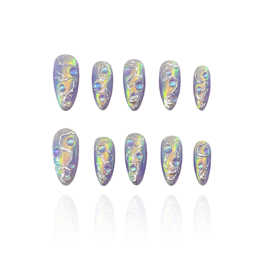 Aurora Tide is a reusable handmade press-on nails set by Leme. The set features a sophisticated chrome finish and a medium almond shape, offering a durable and sleek surface that resists tarnish. Its high-quality 3D design provides depth and texture, enhancing visual appeal while ensuring lasting performance. Ideal for those seeking a refined and modern aesthetic, this piece combines expert craftsmanship with functional elegance.