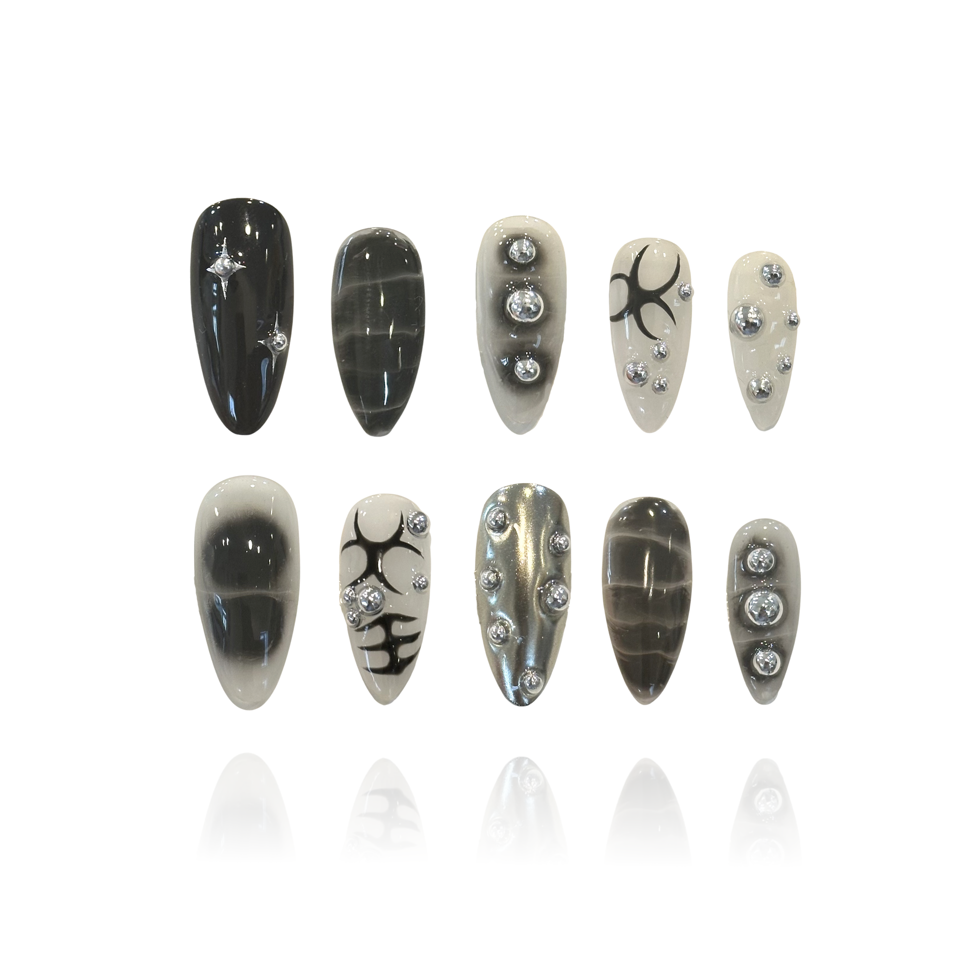 Black Silver Epoch is a reusable handmade press-on nails set by Leme. This set delivers bold, edgy style with a punk rock attitude. Medium almond shape offers a flattering, wearable silhouette that works for everyday wear and statement moments alike. Each set features intricate 3D design work with striking black patterns and silver ball embellishments that catch the light. The dimensional details create depth and texture, elevating these nails beyond flat art—perfect for those who want their manicure to com