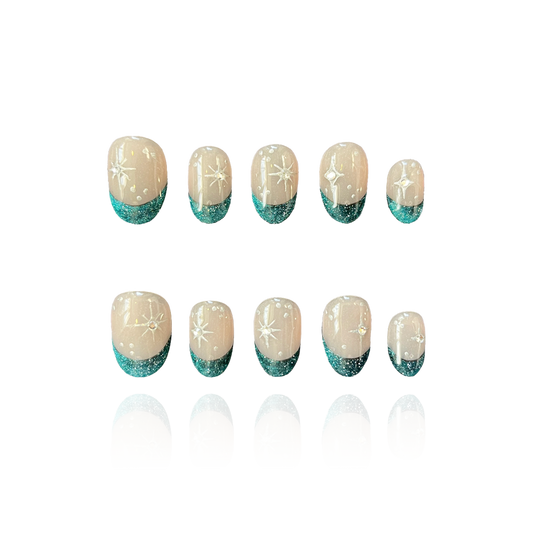 Blue Night is a reusable handmade press-on nails set by Leme. Experience the elegance of our "Blue Night" manicure featuring expertly crafted cat-eye French tips on a subtle nude base. Each short oval-shaped nail is adorned with delicate silver stars and sparkling diamonds, creating a refined and sophisticated look. This design balances understated charm with a touch of luxury, perfect for those seeking a polished and unique style.