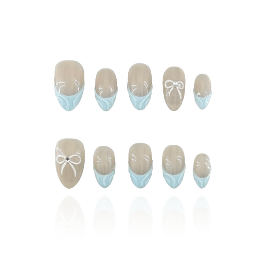 Blue Serenity is a reusable handmade press-on nails set by Leme. These high-quality 3D nails feature a short almond shape with elegant French tips. The delicate baby blue and nude colors create a sophisticated, modern look perfect for any occasion. Designed for durability and style, they offer a flawless finish that enhances your natural nails with expert craftsmanship.