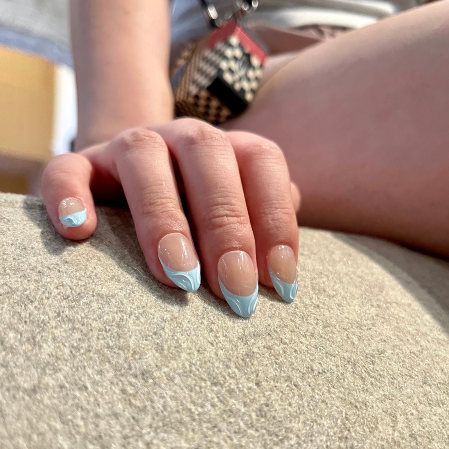 Blue Serenity is a reusable handmade press-on nails set by Leme. These high-quality 3D nails feature a short almond shape with elegant French tips. The delicate baby blue and nude colors create a sophisticated, modern look perfect for any occasion. Designed for durability and style, they offer a flawless finish that enhances your natural nails with expert craftsmanship.