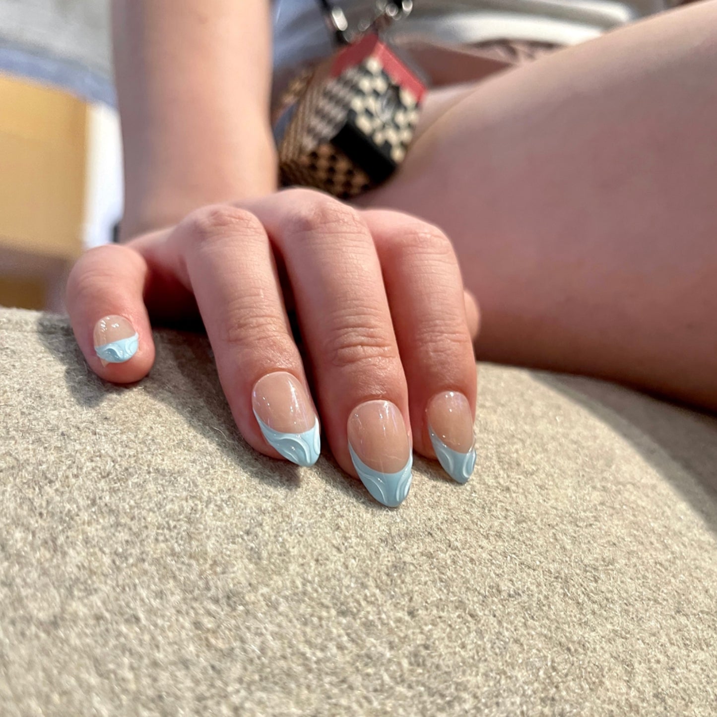 Blue Serenity is a reusable handmade press-on nails set by Leme. These high-quality 3D nails feature a short almond shape with elegant French tips. The delicate baby blue and nude colors create a sophisticated, modern look perfect for any occasion. Designed for durability and style, they offer a flawless finish that enhances your natural nails with expert craftsmanship.