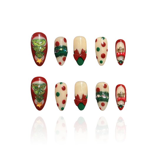 Christmas Song is a reusable handmade press-on nails set by Leme. Celebrate the season with Christmas Song, a sophisticated press-on nail set featuring medium almond-shaped nails in festive green and red. Each nail showcases meticulous artistry: delicate green cat-eye designs adorn the thumbs with a Christmas tree motif and golden cat-eye stars on top. The index and ring fingers feature gem-embellished Christmas wreaths. Dimensional 3D bows on French tips on the middle fingers, and ornate golden bells on th