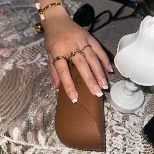 Cream Cloud is a reusable handmade press-on nails set by Leme. The set comes with multiple shapes and lengths. Featuring a refined nude base paired with classic white French tips, this design delivers a polished and versatile look. Made with premium materials, it guarantees long-lasting wear and a smooth, professional finish suitable for any occasion.