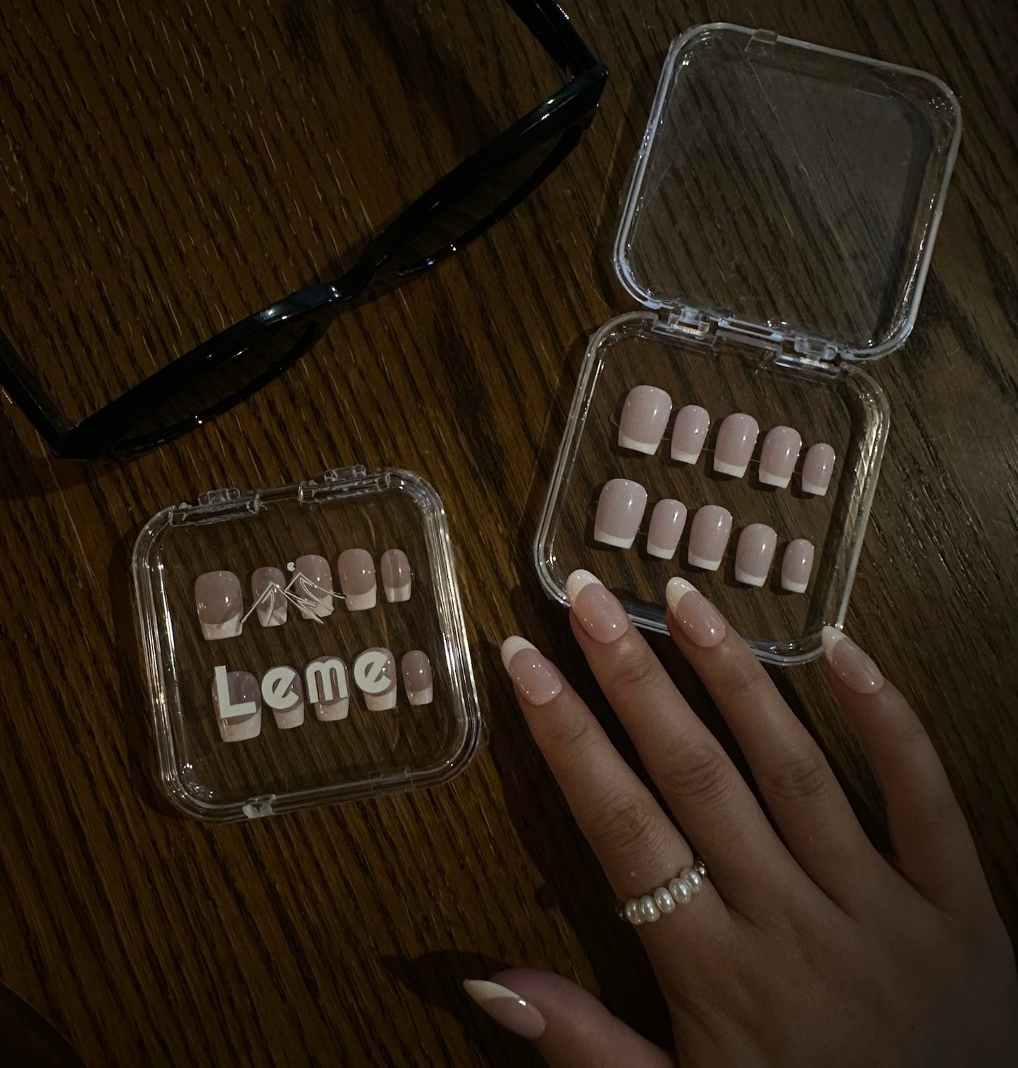 Cream Cloud is a reusable handmade press-on nails set by Leme. The set comes with multiple shapes and lengths. Featuring a refined nude base paired with classic white French tips, this design delivers a polished and versatile look. Made with premium materials, it guarantees long-lasting wear and a smooth, professional finish suitable for any occasion.