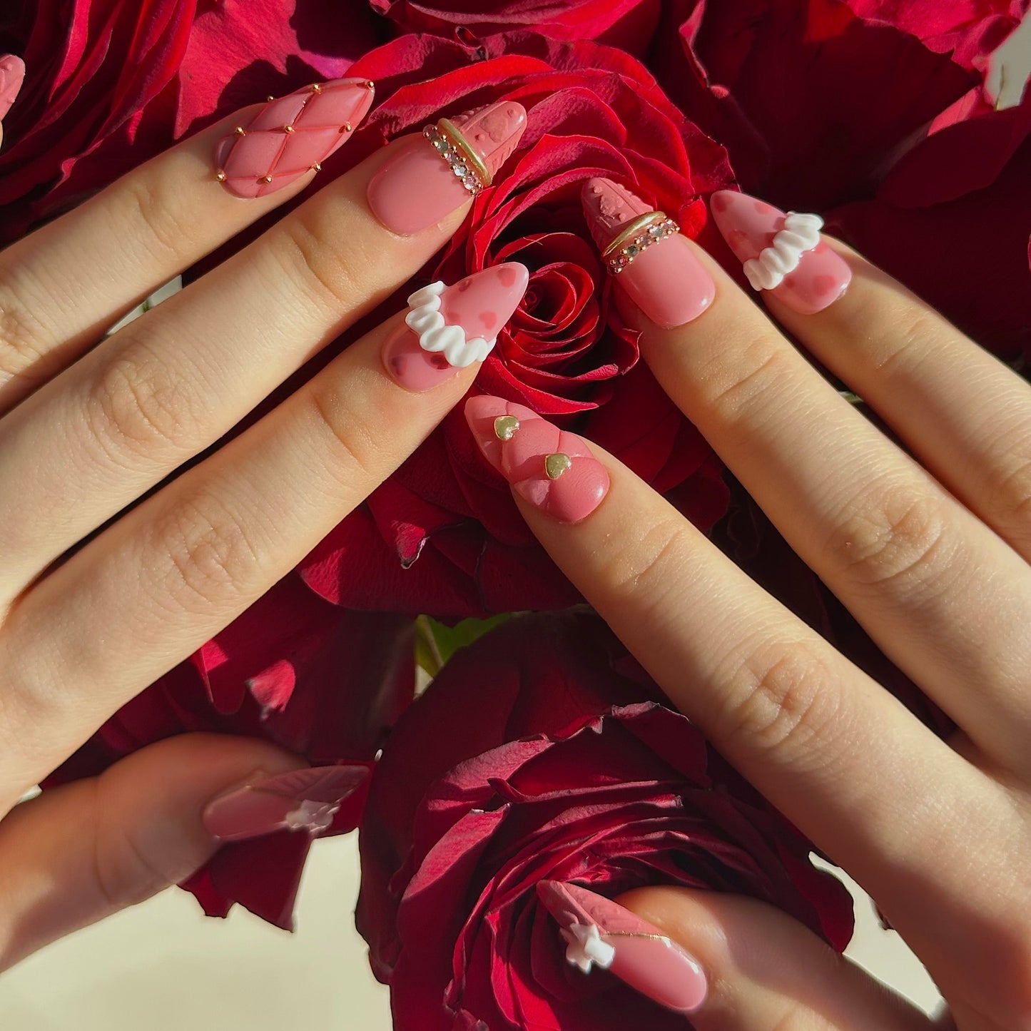 Gold Promise is a reusable handmade press-on nails set by Leme. Discover Gold Promise, an exquisite nail collection that captures timeless elegance through meticulous craftsmanship. These medium almond-shaped nails feature a romantic pink base paired with classic French tips adorned in a soft sweater texture for subtle sophistication. The design showcases premium 3D embellishments complemented by strategically placed gems and gold chrome accents that form delicate ring-like details across the nail surface. 