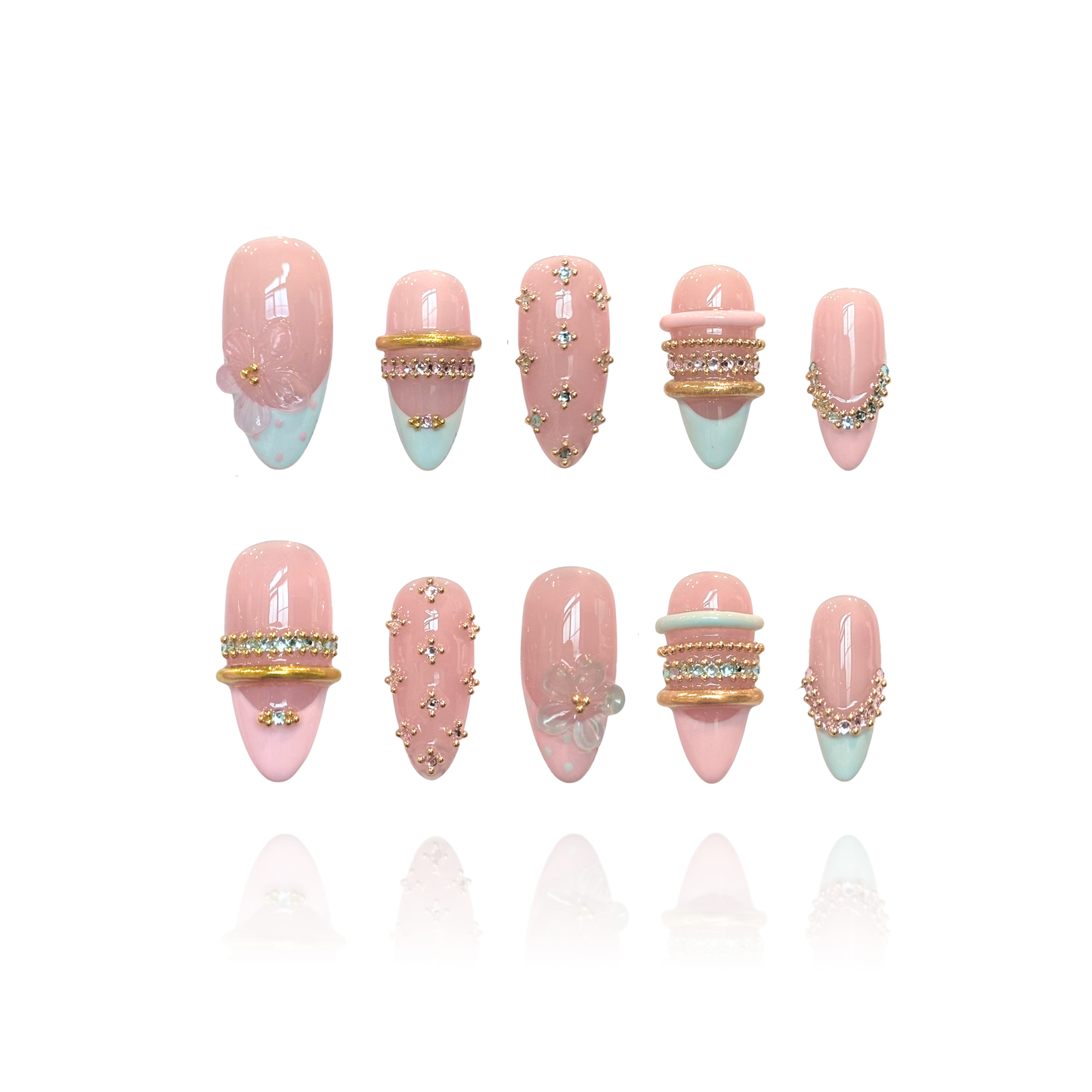 Gold Spark is a reusable handmade press-on nails set by Leme. Elevate your nail game with Gold Spark, a stunning collection of medium almond-shaped press-on nails featuring intricate French tips and playful polka dot designs. Each nail is adorned with luxurious 3D decorations, delicate gold bangles, and shimmering blue and pink diamond accents that catch the light with every gesture. Crafted from high-quality materials, these nails deliver a salon-perfect finish with a complex, eye-catching design that make