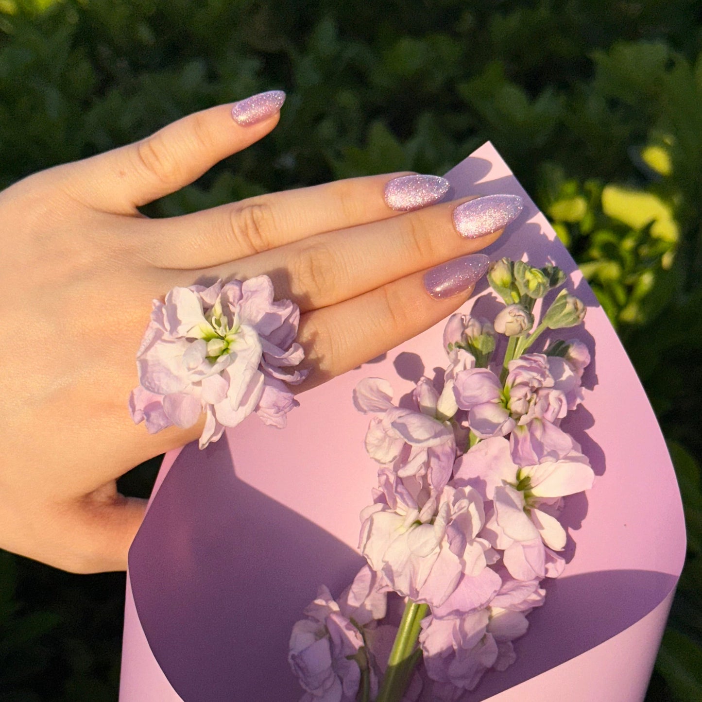 Grape Meteor is a reusable handmade press-on nails set by Leme. High-quality handmade press-on nails in a stunning violet chunky cat-eye finish for maximum sparkle and dimension. Available in various shapes to suit your style. Let violet blooms on your fingertips. 
