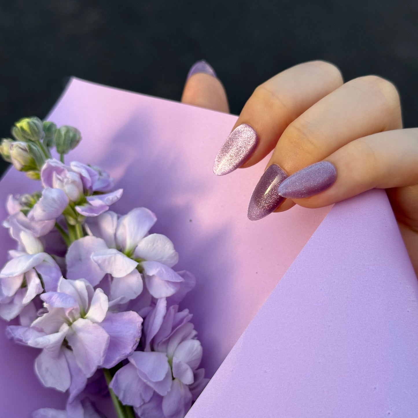 Grape Meteor is a reusable handmade press-on nails set by Leme. High-quality handmade press-on nails in a stunning violet chunky cat-eye finish for maximum sparkle and dimension. Available in various shapes to suit your style. Let violet blooms on your fingertips. 