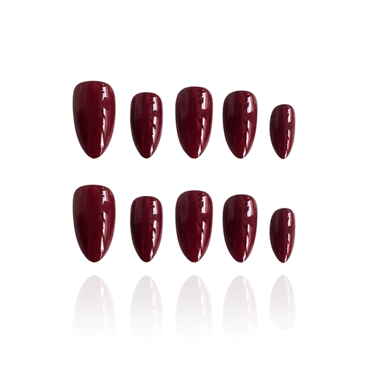 Grown up is a reusable handmade press-on nails set by Leme. Sophisticated short almond nails in a deep wine red that commands attention. Handcrafted with premium materials for a flawless finish and comfortable wear. The rich, elegant shade pairs effortlessly with any occasion—from everyday elegance to evening glamour. Reusable and durable, these nails deliver salon-quality results at home. Perfect for those who appreciate timeless style with a bold edge.