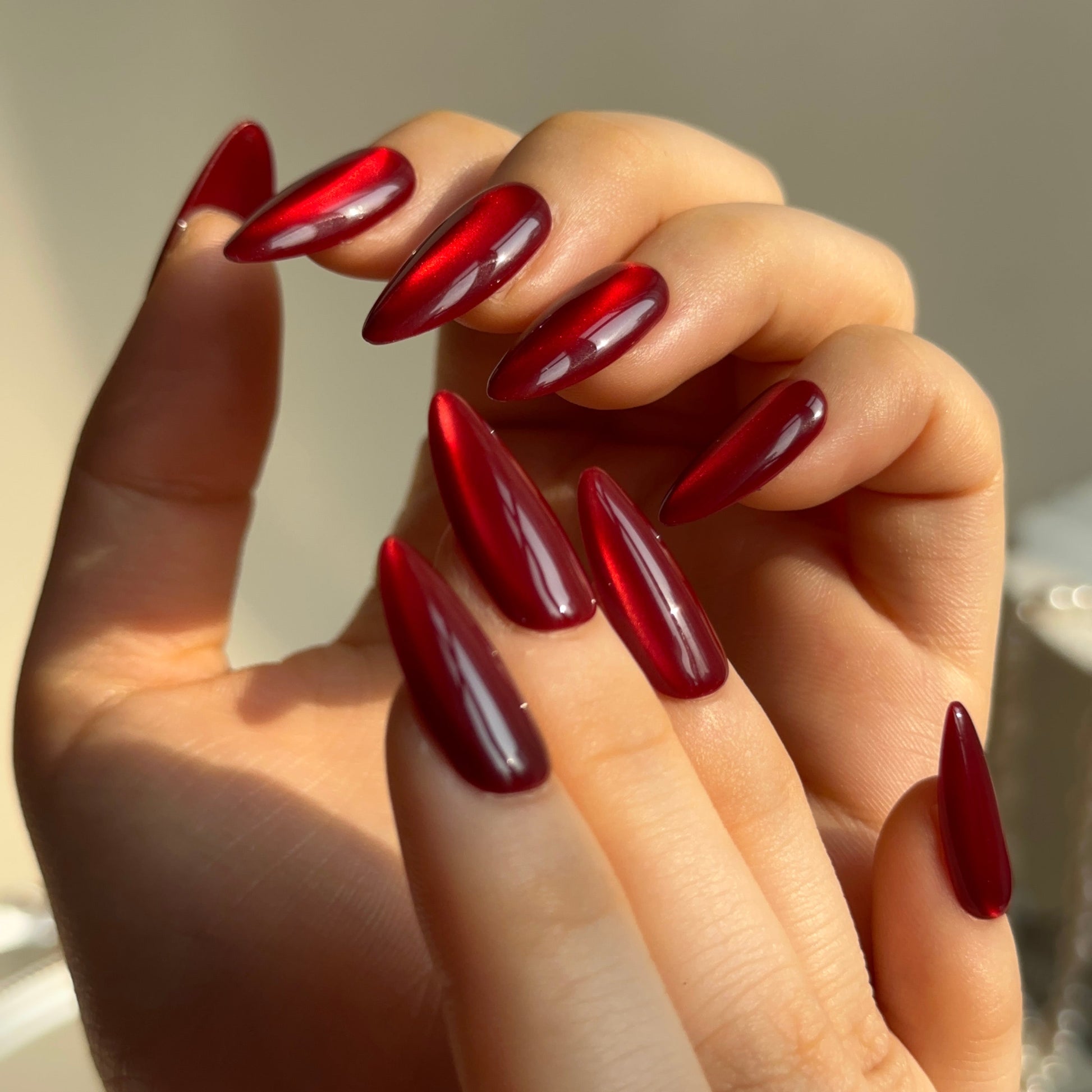 Hickey is a reusable handmade press-on nails set by Leme. Make a statement this Valentine's Day with these expertly designed press-on nails. Featuring a sophisticated medium almond shape and striking hot red cat-eye design, they deliver instant glamour and a distinctly sexy aesthetic. Each nail is crafted from premium materials for superior durability and a flawless finish. Quick to apply and built to last, these nails are your shortcut to salon-quality elegance without the commitment.