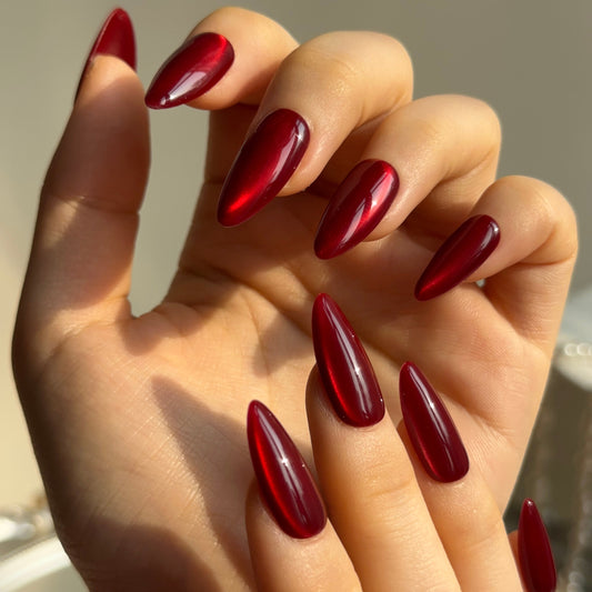 Hickey is a reusable handmade press-on nails set by Leme. Make a statement this Valentine's Day with these expertly designed press-on nails. Featuring a sophisticated medium almond shape and striking hot red cat-eye design, they deliver instant glamour and a distinctly sexy aesthetic. Each nail is crafted from premium materials for superior durability and a flawless finish. Quick to apply and built to last, these nails are your shortcut to salon-quality elegance without the commitment.