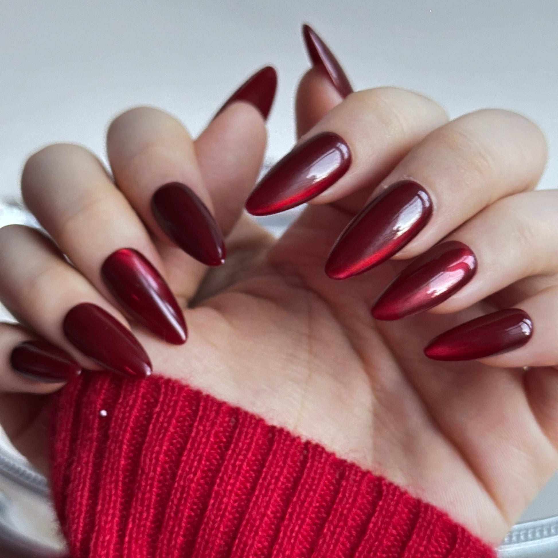 Hickey is a reusable handmade press-on nails set by Leme. Make a statement this Valentine's Day with these expertly designed press-on nails. Featuring a sophisticated medium almond shape and striking hot red cat-eye design, they deliver instant glamour and a distinctly sexy aesthetic. Each nail is crafted from premium materials for superior durability and a flawless finish. Quick to apply and built to last, these nails are your shortcut to salon-quality elegance without the commitment.