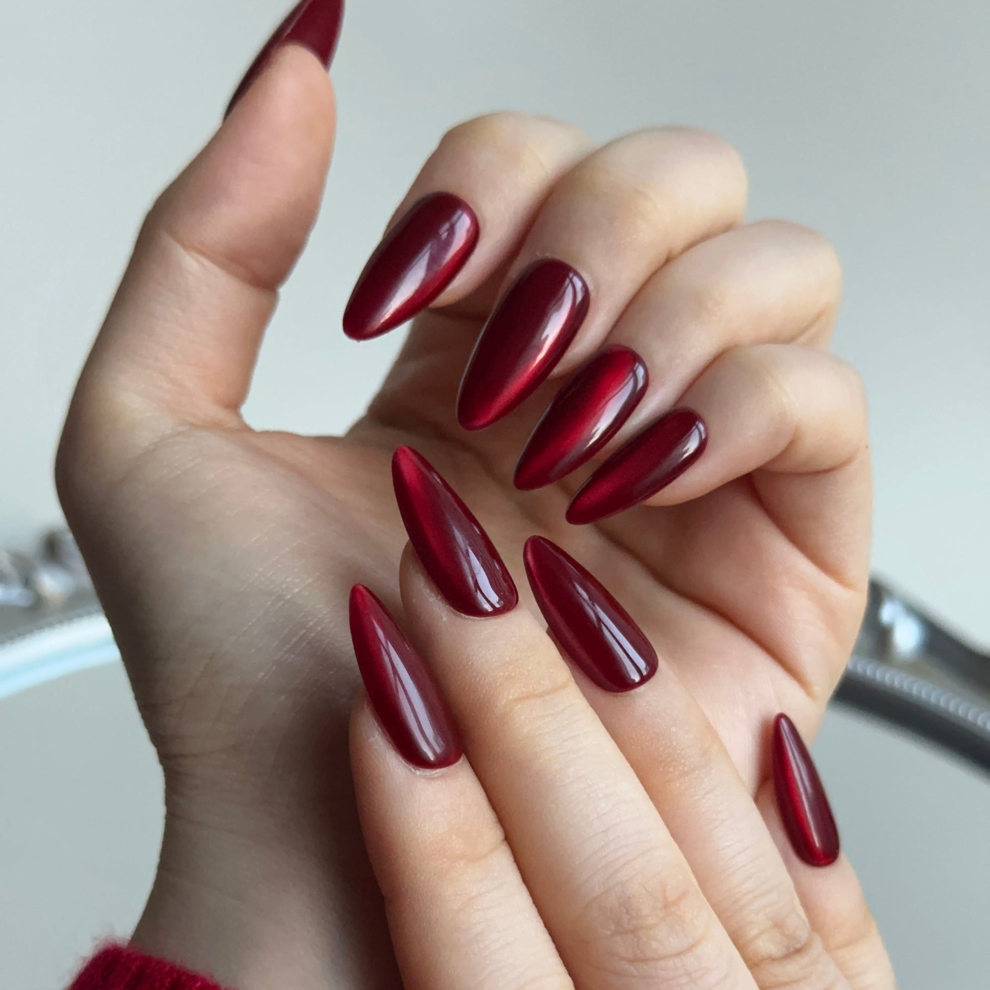Hickey is a reusable handmade press-on nails set by Leme. Make a statement this Valentine's Day with these expertly designed press-on nails. Featuring a sophisticated medium almond shape and striking hot red cat-eye design, they deliver instant glamour and a distinctly sexy aesthetic. Each nail is crafted from premium materials for superior durability and a flawless finish. Quick to apply and built to last, these nails are your shortcut to salon-quality elegance without the commitment.