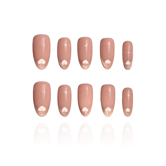 Love Letter is a reusable handmade press-on nails set by Leme. Elevate your manicure with Love Letter, a sophisticated medium oval nail design that captures timeless elegance. These cat-eye French tips feature a delicate pink nude base adorned with hand-drawn hearts, blending classic refinement with romantic detail. The expertly crafted medium oval shape flatters any hand, while the precise cat-eye finish adds dimension and depth. Whether you're planning a romantic evening or simply embracing the season of 