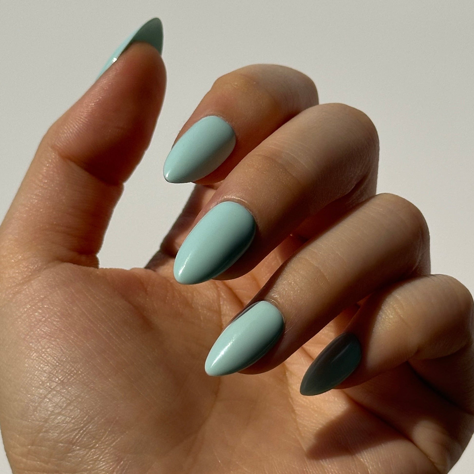 Mint is a reusable handmade press-on nails set by Leme. The set featuring a light creamy turquoise shade inspired by cool summer breezes. Available in various short shapes, this collection showcases soft macaron color tones that complements any season. Crafted with high-quality materials, each set is designed for durability and effortless application, making it perfect for everyday wear or special occasions.