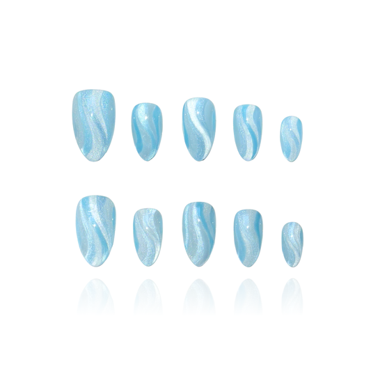 Ocean Ripple is a reusable handmade press-on nails set by Leme. Elevate your nail game with Ocean Ripple—a stunning collection of short almond-shaped press-on nails featuring mesmerizing blue cat-eye ripple designs. Each set captures the essence of ocean waves with a chic, dynamic finish that truly comes alive under flashlight. Premium quality craftsmanship ensures a flawless look that's both sophisticated and eye-catching. Perfect for those seeking a bold statement with an elegant edge.