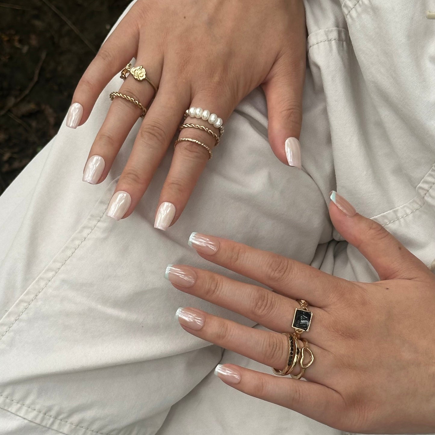 Ocean Breeze is a reusable handmade press-on nails set by Leme. Elevate your manicure with these expertly crafted press-on nails featuring a nude base and delicate baby blue French tips. The set comes with multiple shapes and lengths. Finished with a high-quality chrome sheen, this design offers a modern twist on a classic style, ensuring durability and a polished look that lasts. Perfect for those seeking subtle elegance with a contemporary edge.