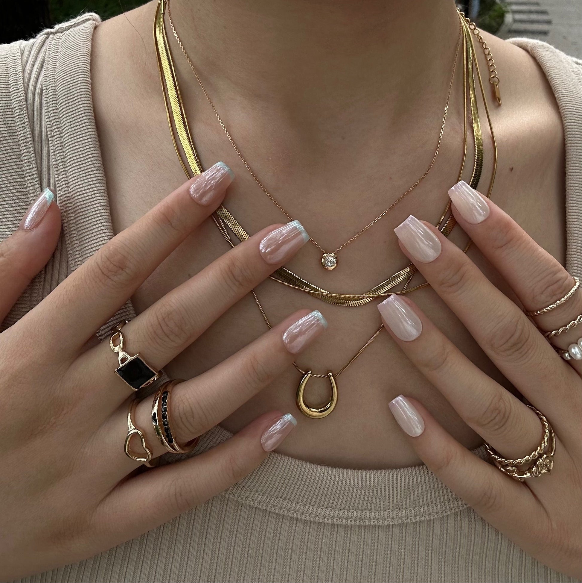 Ocean Breeze is a reusable handmade press-on nails set by Leme. Elevate your manicure with these expertly crafted press-on nails featuring a nude base and delicate baby blue French tips. The set comes with multiple shapes and lengths. Finished with a high-quality chrome sheen, this design offers a modern twist on a classic style, ensuring durability and a polished look that lasts. Perfect for those seeking subtle elegance with a contemporary edge.