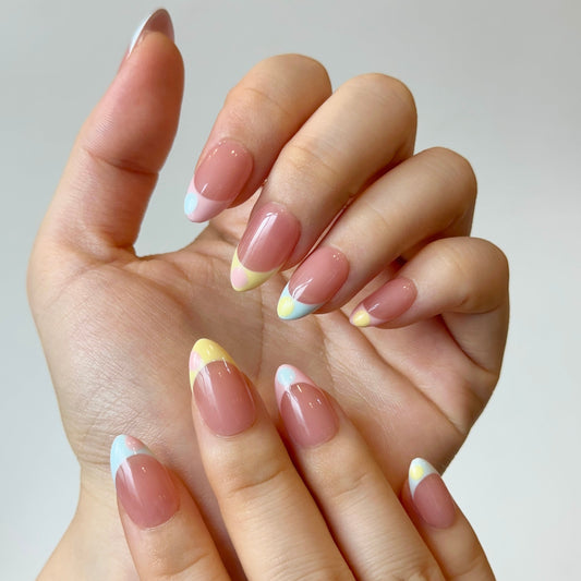 Pastel Polka is a reusable handmade press-on nails set by Leme. High-quality almond-shaped press-on nails with a soft pink nude base and playful summer aesthetic. Features pastel French tips in pink, blue, and yellow adorned with cute oversized polka dots. Perfect for adding a cheerful, on-trend look to your nails in seconds.