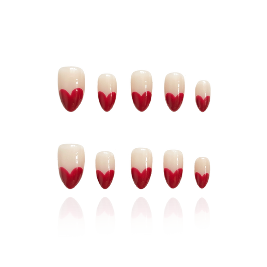 Retro Heart  is a reusable handmade press-on nails set by Leme. This collection features short almond-shaped nails in classic red and nude tones. Handmade with high-quality materials, these reusable nails offer a sophisticated French-inspired look that combines timeless style with durability. Perfect for those seeking a refined, expert touch to their manicure routine.