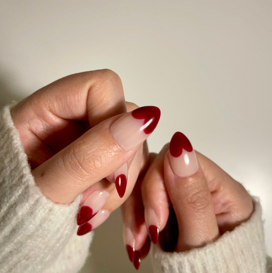 Retro Heart  is a reusable handmade press-on nails set by Leme. This collection features short almond-shaped nails in classic red and nude tones. Handmade with high-quality materials, these reusable nails offer a sophisticated French-inspired look that combines timeless style with durability. Perfect for those seeking a refined, expert touch to their manicure routine.