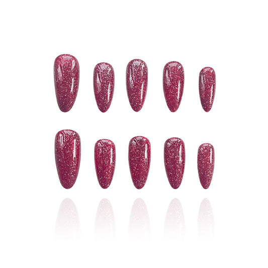 Sweatheart is a reusable handmade press-on nails set by Leme.Elevate your Valentine's Day look with these stunning medium almond-shaped nails featuring a sophisticated raspberry pink glitter base. Each nail is meticulously crafted with premium quality materials to ensure durability and a flawless finish. The intricate firework alike design adds depth and dimension, creating a captivating sparkle that catches the light beautifully. Perfect for the season of love, these nails deliver both elegance and eye-cat
