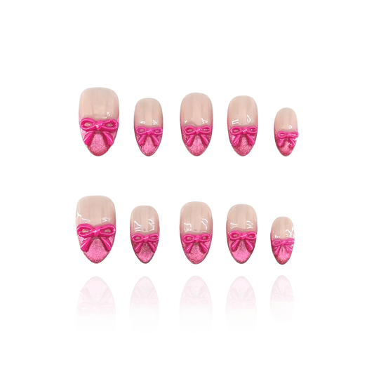 Sassy Diva is a reusable handmade press-on nails set by Leme. Elevate your manicure with the Sassy Diva nails, featuring a short almond shape and classic French tips enhanced by a vibrant hot pink cat-eye effect. Each nail is adorned with a delicate pink bow tie over a nude base, combining elegance with a playful edge. Crafted with high-quality materials, these nails offer durability and a flawless finish for a confident, expert look.