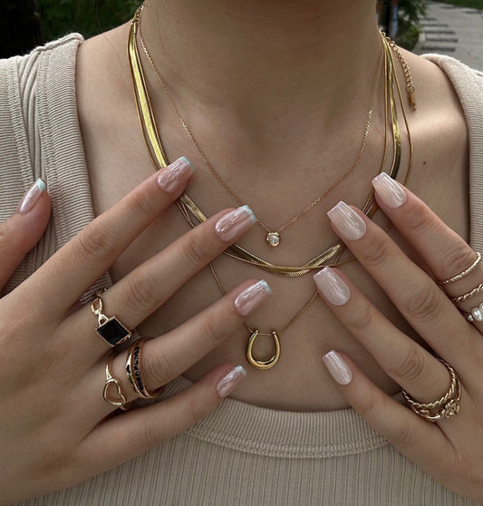 Silky Taro is a reusable handmade press-on nails set by Leme. This elegant nail design features a nude base complemented by delicate light milky purple French tips, offering a subtle yet sophisticated look. The sleek chrome finish delivers a pearl-like shine and an elegance edge. The set comes with multiple shapes and lengths. Crafted with high-quality materials, it ensures durability and a smooth finish, perfect for those seeking a refined and modern manicure. Ideal for both everyday wear and special occas