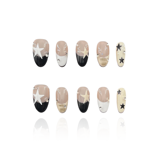 Starry Chic is a reusable handmade press-on nails set by Leme. Elevate your nails with the Starry Chic design, featuring an oval shape and a nude base that highlights cute black and white French tips. Accented with creamy yellow hues, delicate stars, and small diamonds, this high-quality press-on nails set offers a sophisticated yet playful look perfect for any occasion.