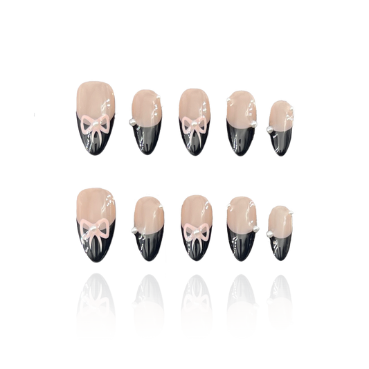 Tie Me is a reusable handmade press-on nails set by Leme. Elevate your nail style with "Tie Me," featuring expertly crafted almond-shaped nails and intricate 3D designs. These high-quality nails showcase a chic nude base accented by elegant black French tips and a delicate pink bow tie design, combining sophistication with a playful touch. Perfect for those seeking a refined yet unique manicure look.