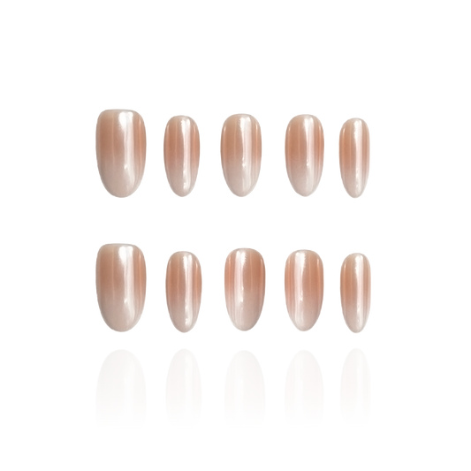 Tipsy is a reusable handmade press-on nails set by Leme. Featuring a medium-length oval shape, each nail showcases a high-quality chrome finish with a seamless gradient from nude to pristine white. This sophisticated design delivers a subtle yet striking appearance, ideal for those who appreciate refined, modern style with lasting wear.