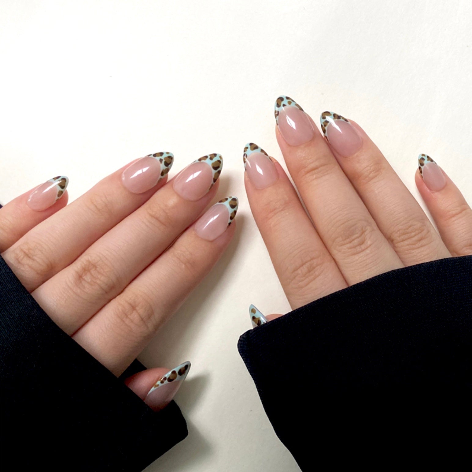Mint Leopard is a reusable handmade press-on nails set by Leme. Enhance your manicure with these expertly designed French tips featuring a mint-colored leopard pattern. Featuring a nude base and a short almond shape, this design combines subtle elegance with a bold, modern twist. Made with high-quality materials, these nails offer durability and a flawless finish, perfect for those seeking a sophisticated yet trendy look.