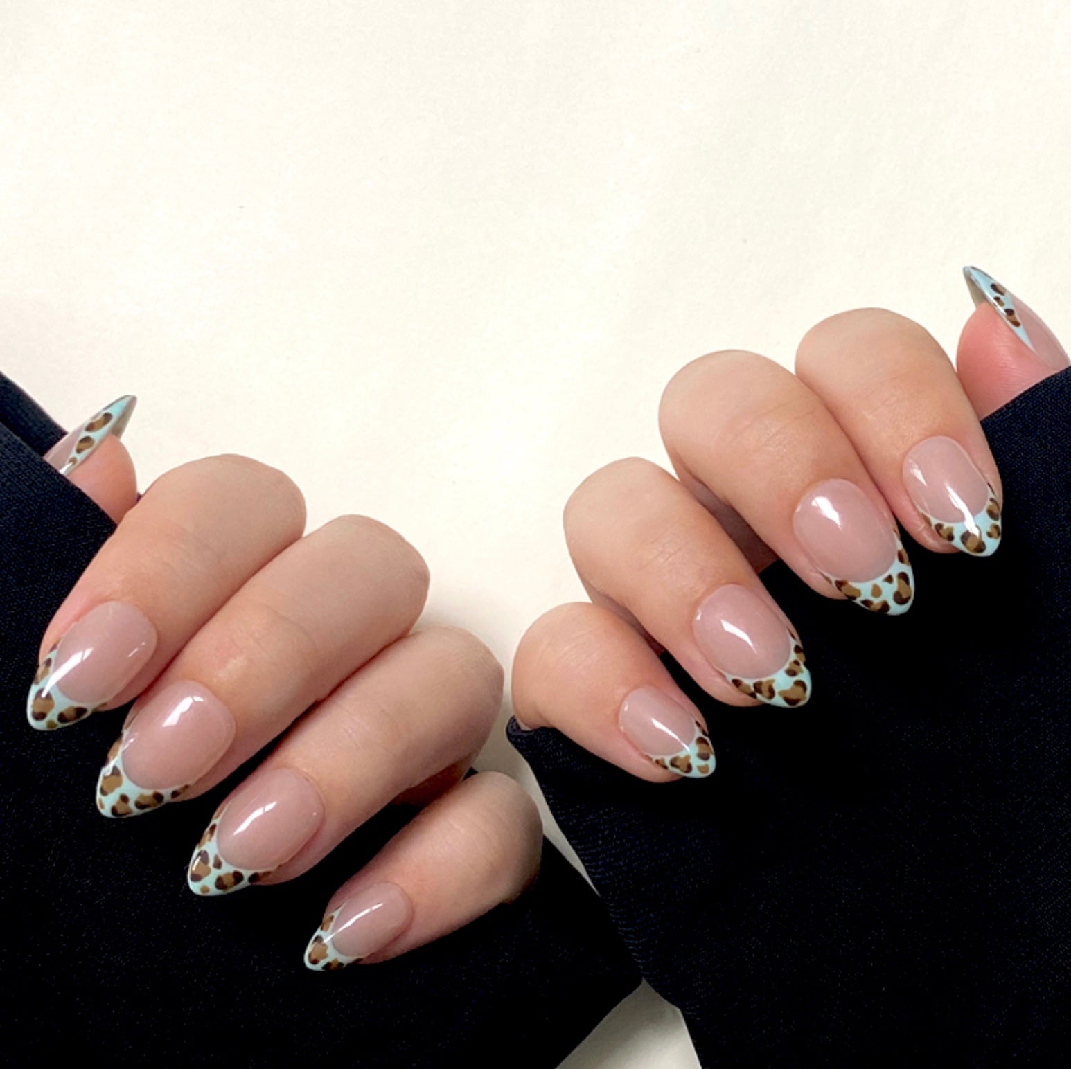 Mint Leopard is a reusable handmade press-on nails set by Leme. Enhance your manicure with these expertly designed French tips featuring a mint-colored leopard pattern. Featuring a nude base and a short almond shape, this design combines subtle elegance with a bold, modern twist. Made with high-quality materials, these nails offer durability and a flawless finish, perfect for those seeking a sophisticated yet trendy look.